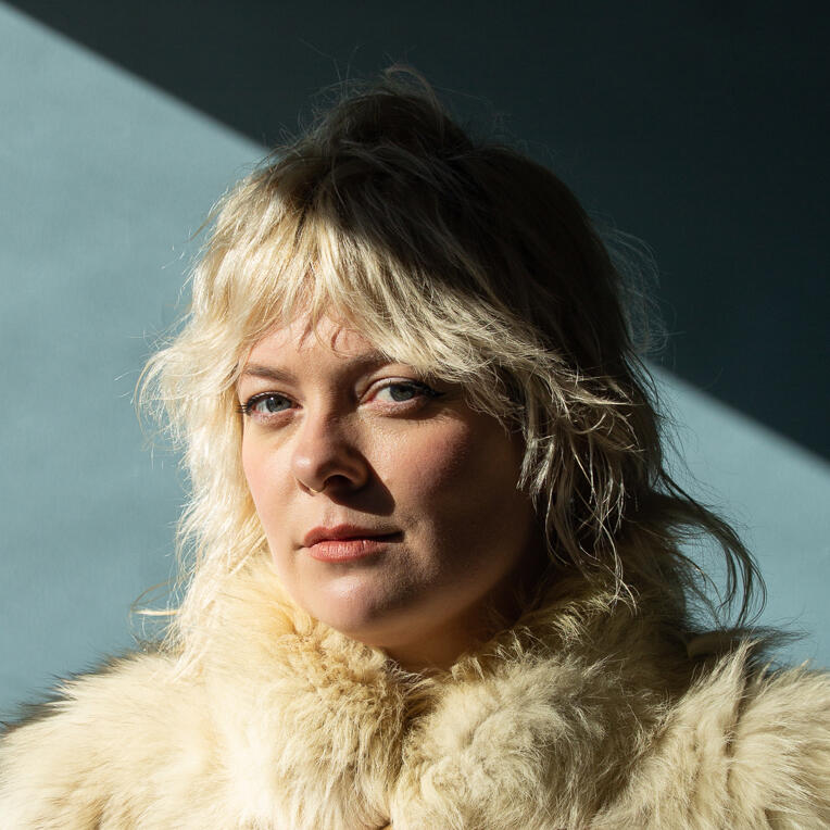 Photo of Fitch with blonde spikey hair and a yummy fur coat